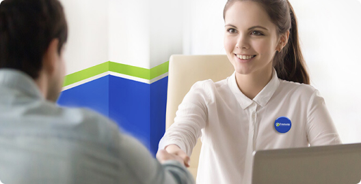 Image of two people in front of a laptop